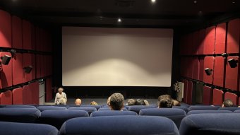 Attendees seated for the film “The Seed of the Sacred Fig” to begin showing at Metropolis. April 20, 2024. (Mahdi El Amin/Raseef22)